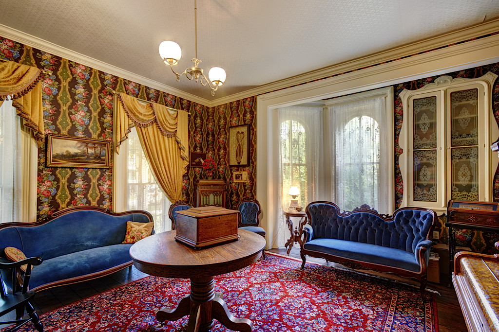 The parlor has plenty of light with its own bay window as well as two windows looking out the front of the home. The built-in cabinet was added when the dining room was built extending to the east.